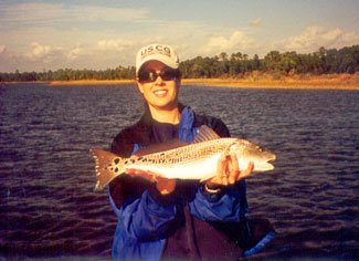 Angler with a Panama City redfish at golden hour